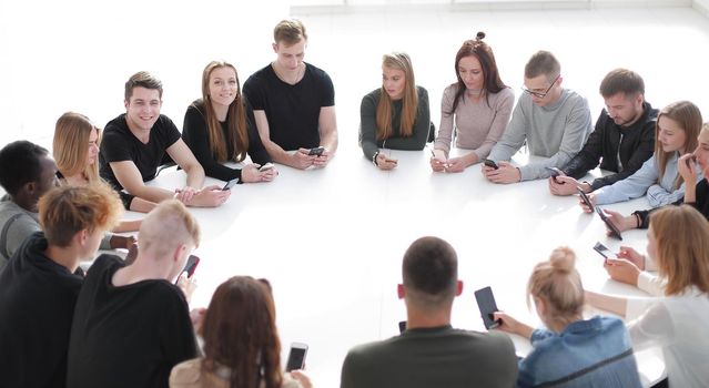 study group of young people sitting at a round table . photo with copy space