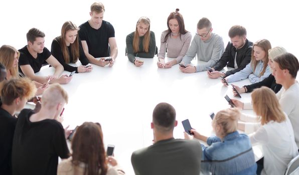 study group of young people sitting at a round table . photo with copy space