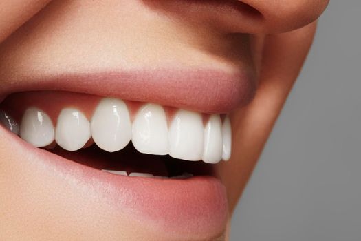 Beautiful smile with whitening teeth. Dental photo. Macro closeup of perfect female mouth, lipscare rutine.