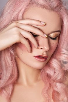 Beautiful Woman with Curly Colored Hairstyle and Fashion Make-up. Beauty Soft-Girl Style with Tender Pink Hair, Yellow French Manicure, Spring Makeup. Valentines Day, March 8 or Womens Day Look