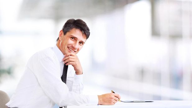Handsome business man smiling at the office