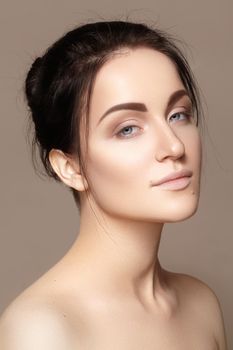 Beautiful young woman with perfect clean shiny skin, natural fashion makeup. Close-up woman, fresh spa look. Healthy beauty