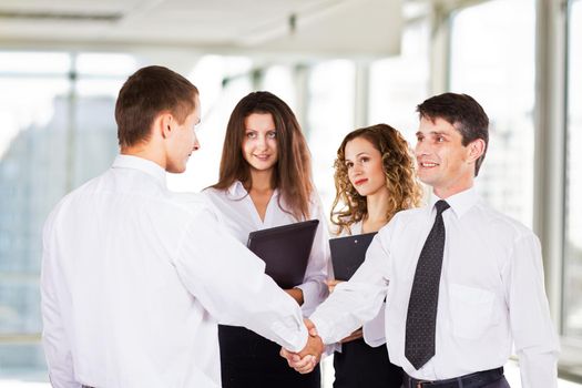 A group of successful businessmen. Conclusion a very important transaction.