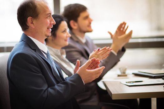 Close-up of business people clapping hands. Business seminar concept