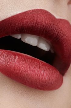 Close-up of female lips with bright makeup. Macro of woman's face. Fashion lip make-up with red gloss.Red lipgloss makeup on full female lips