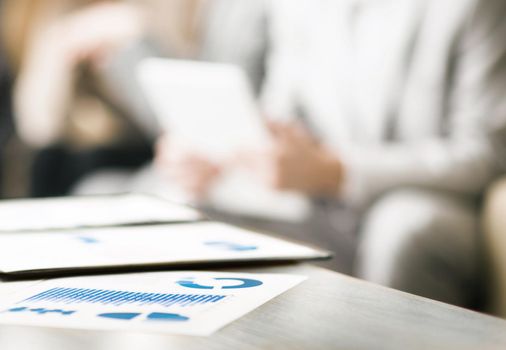 Image of business documents with working team communicating background