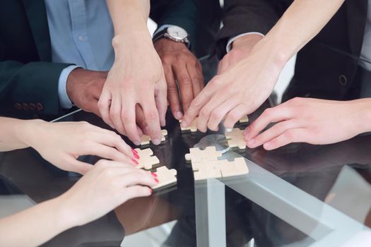 closeup .multinational business team assembling puzzle.the concept of strategy in business