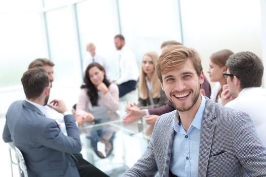 smiling business man on the background of the business office . photo with copy space