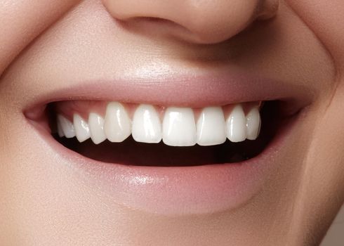 Beautiful smile with whitening teeth. Dental photo. Macro closeup of perfect female mouth, lipscare rutine.