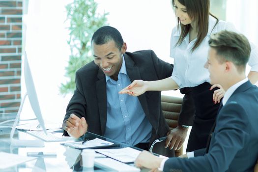 smiling business team talking ,sitting at their Desk in the office