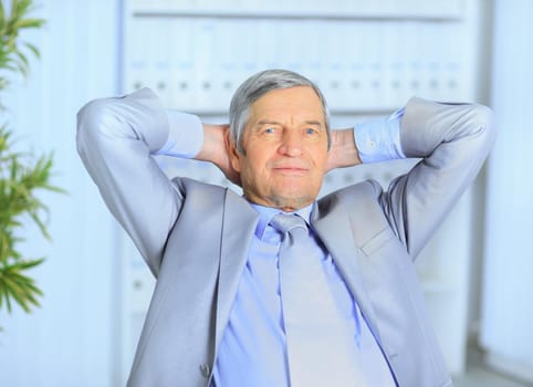 Businessman in age, resting for a break. Isolated on a white background.