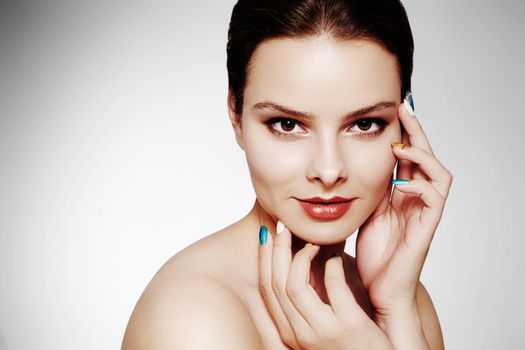 Beautiful model with fashion make-up. Close-up portrait sexy woman with glamour lip gloss makeup and bright eye shadows. Shot of celebrate visage, clean skin, lips with red lipstick, eyeshadows.