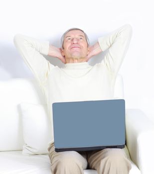 Adult male at home resting for a laptop.