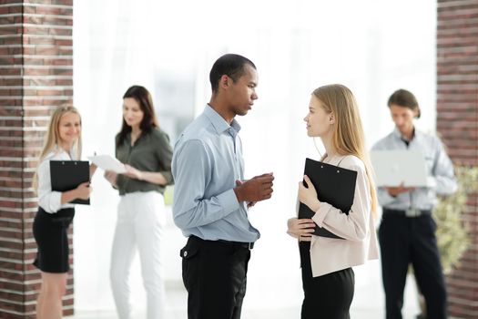 employees discussing business document standing in the office .people and technology