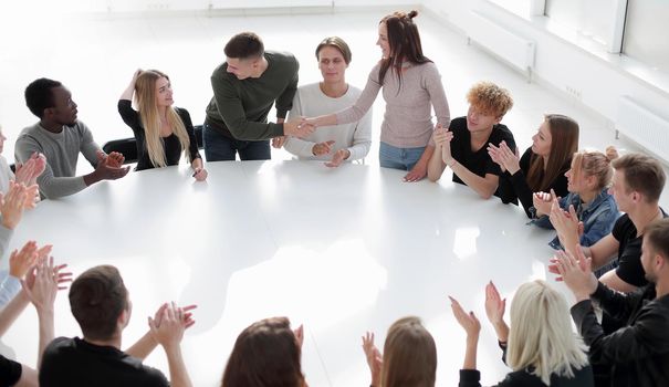 young seminar participants shaking hands . photo with space for text