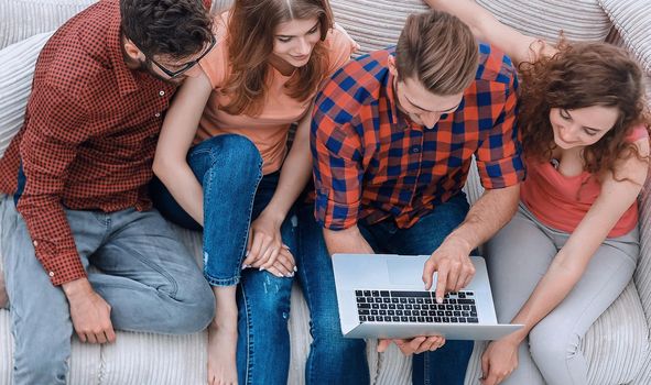 view from the top. the group of friends with a laptop,discussing the video