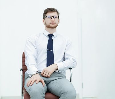 confident businessman sitting in a chair.photo with copy space