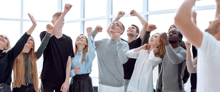 happy group of young people looking somewhere up. photo with copy space