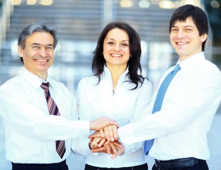 business team putting their hands on top of each other