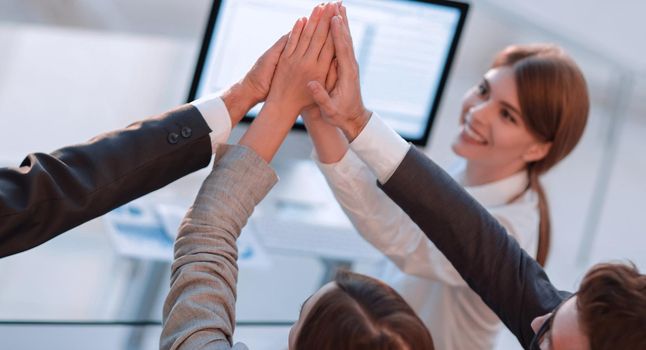 successful business team giving each other a high five. the concept of success.