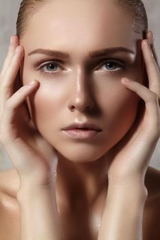 Beautiful young woman with perfect clean shiny skin, natural fashion makeup. Close-up woman, fresh spa look. Healthy beauty
