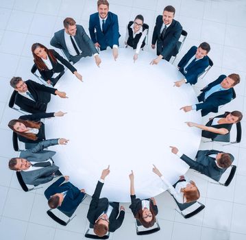 view from the top.business team indicates the center of the round table. the photo has a blank space for text