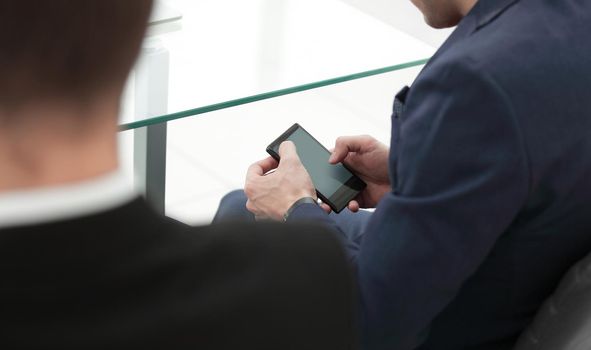 close up.businessman using smartphone in the workplace in the office