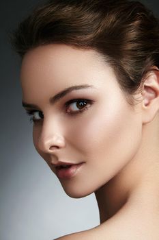 Beautiful face of young woman. Skincare, wellness, spa. Clean soft skin, healthy fresh look. Natural daily makeup.