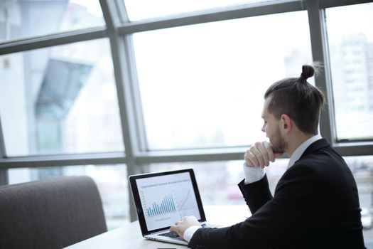 successful businessman working with financial charts on the laptop.