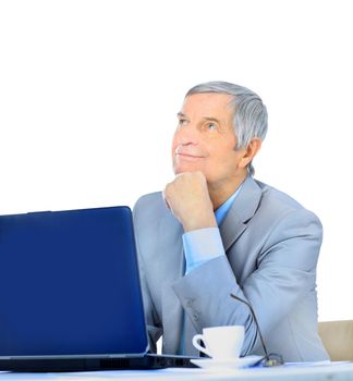 The businessman at the age of works for the laptop. Isolated on a white background.