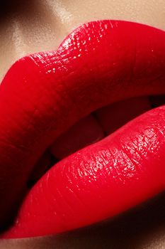 Beautiful female Lips. Sweet Kiss with red lipstick. Lip Make-up on macro shoot. Hot fashion lip makeup. Great for Valentines day