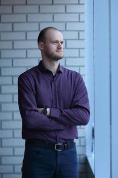 pensive businessman looking out office window.business people