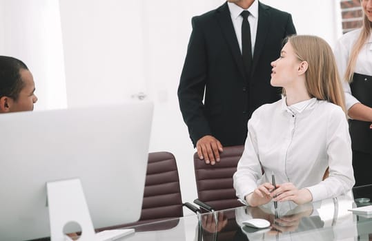 closeup.the employees are talking in a modern office.office life