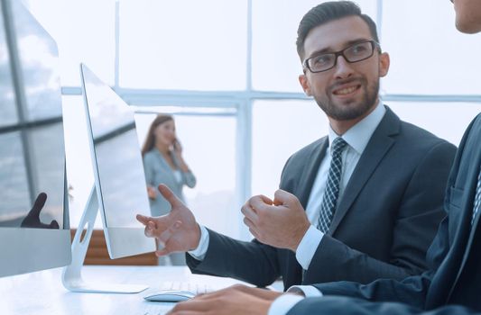 business colleagues sitting at their Desk on blurred background office