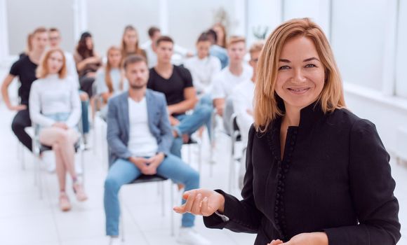 smiling business woman standing in conference room. business and education