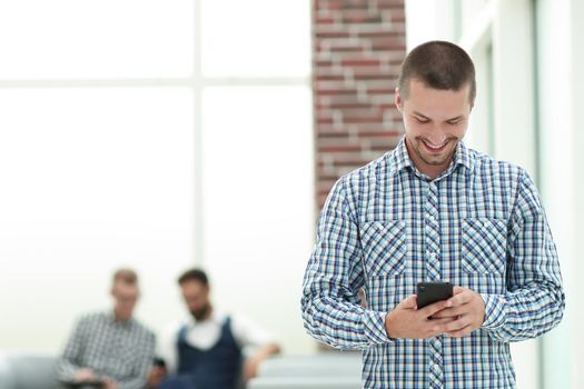 young man reading a SMS on his smartphone.people and technology