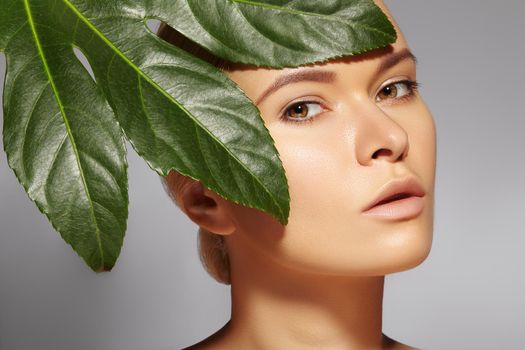 Beautiful woman applies Organic Cosmetic and oils for Beauty. Spa and Wellness. Model with Clean Skin, shiny hair. Healthcare.