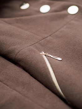 Close up of fashionable womens brown coat. Low DOF.