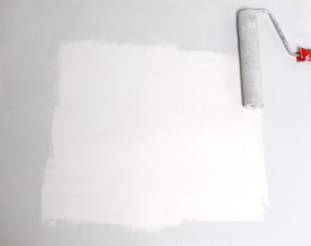 square painted white with the paint roller, on a white sheet of paper.place for text.