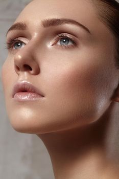 Beautiful young woman with perfect clean shiny skin, natural fashion makeup. Close-up woman, fresh spa look. Healthy beauty