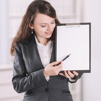 modern business woman pointing at blank sheet. .photo with copy space