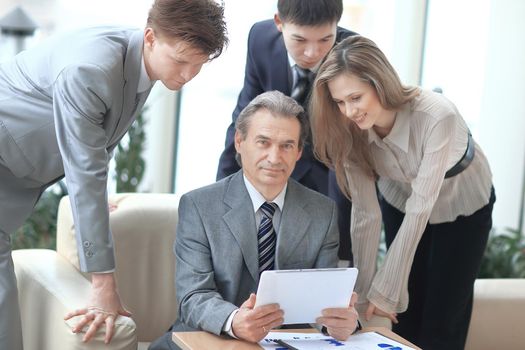 businessman and his colleagues sitting at the table in the office.