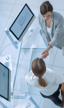 view from the top.business woman shaking hands with employee .business concept