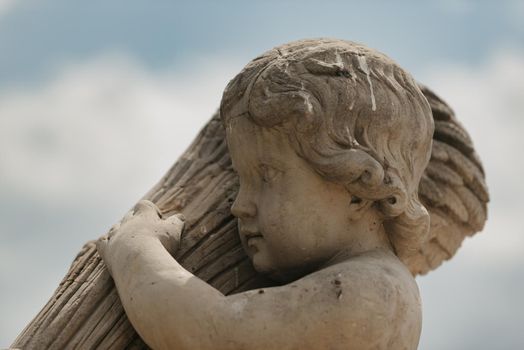 Warsaw, Poland - MAY 12, 2022: The headshot of an old sculpture of the child in Royal Baths Park, Lazienki Park