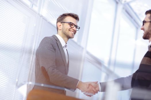 close up.modern man shaking hand with the Manager.