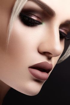 Closeup portrait with of beautiful woman face. Fashion makeup, clean shiny skin. Makeup and cosmetic. Beauty style on model face. Blond hair style