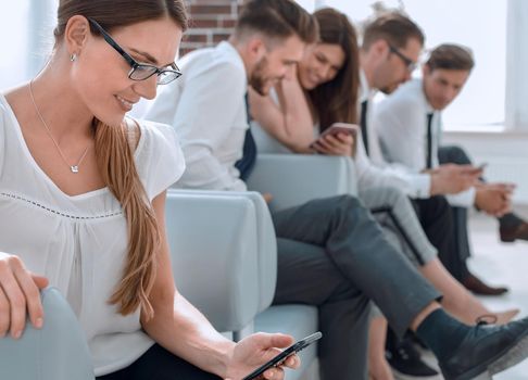 in the foreground.a young business woman is waiting for an interview.people and technology