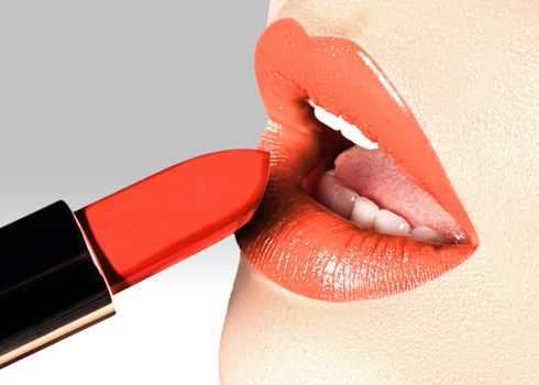 Beautiful female lips with fashion make-up. Trend light coral color. Makeup, visage and cosmetics. Part of female face. Macro shot of beautiful make up on full lips. Choice lipstick