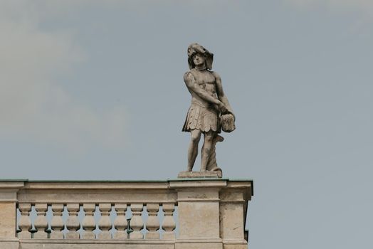 Warsaw, Poland - MAY 12, 2022: The photo in full length of old sculpture on the roof of the Palace on the Isle in Royal Baths Park, Lazienki Park