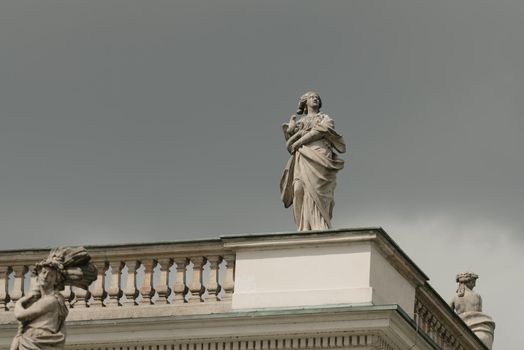 Warsaw, Poland - MAY 12, 2022: The photo in full length of old sculpture on the roof of the Palace on the Isle in Royal Baths Park, Lazienki Park